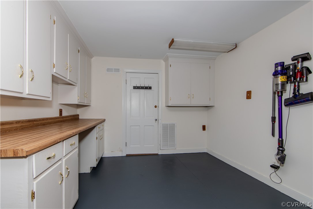 7706 Comanche Drive Richmond, VA 23225 - Photo 24 of 42 a kitchen with cabinets and wooden floor