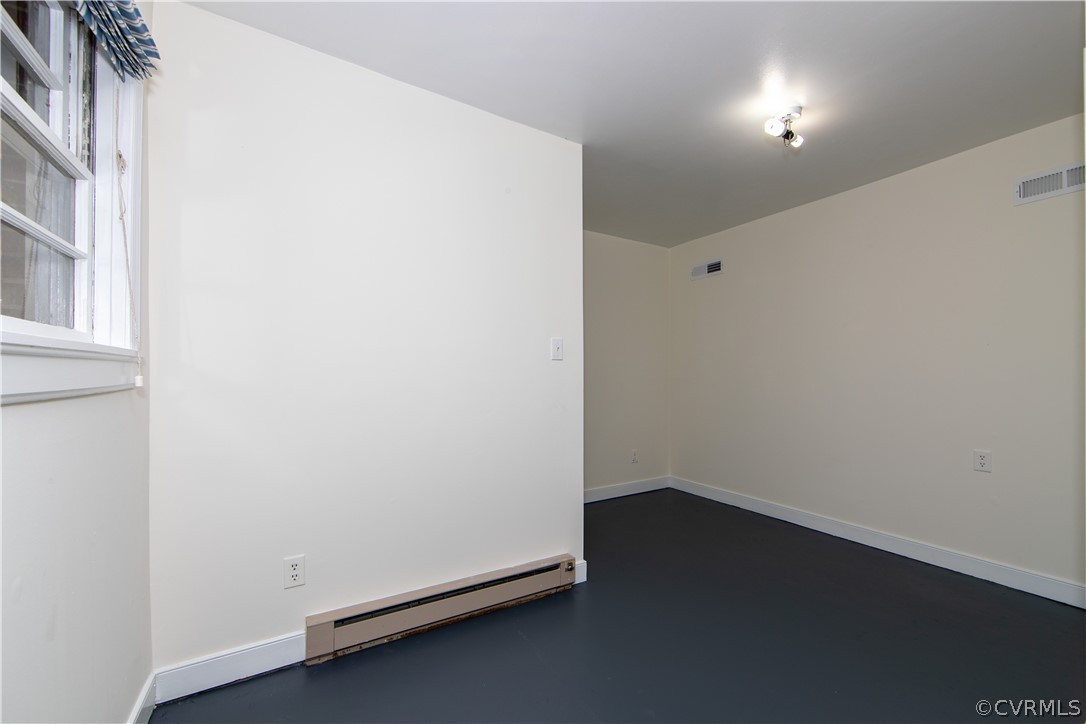 7706 Comanche Drive Richmond, VA 23225 - Photo 27 of 42 an empty room with a wooden floor and a window