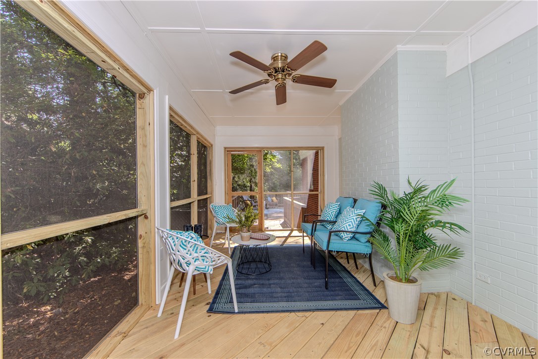 7706 Comanche Drive Richmond, VA 23225 - Photo 29 of 42 a living room with furniture a potted plant and a large window