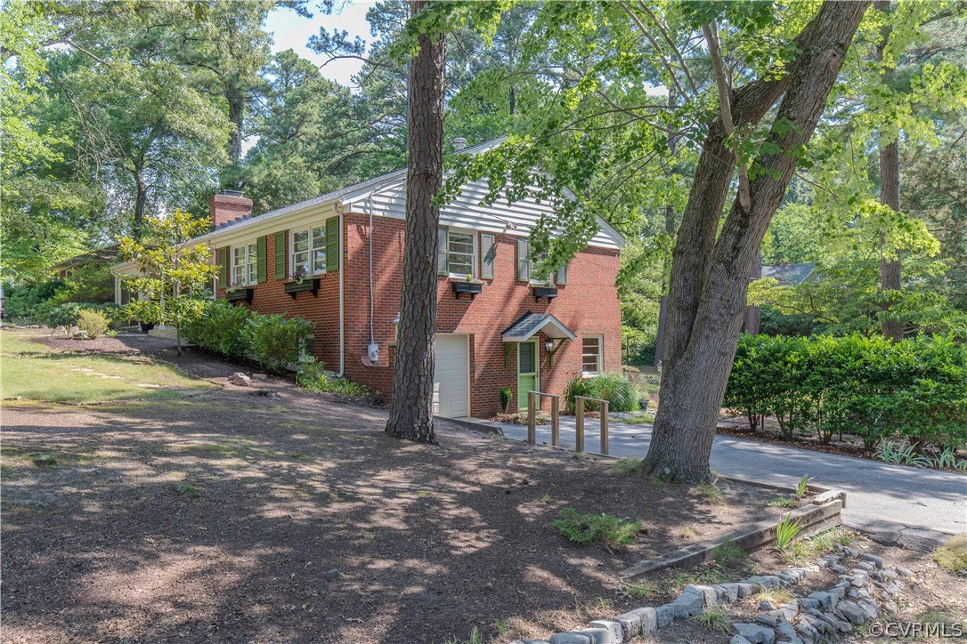 7706 Comanche Drive Richmond, VA 23225 - Photo 4 of 42 a front view of a house with a tree