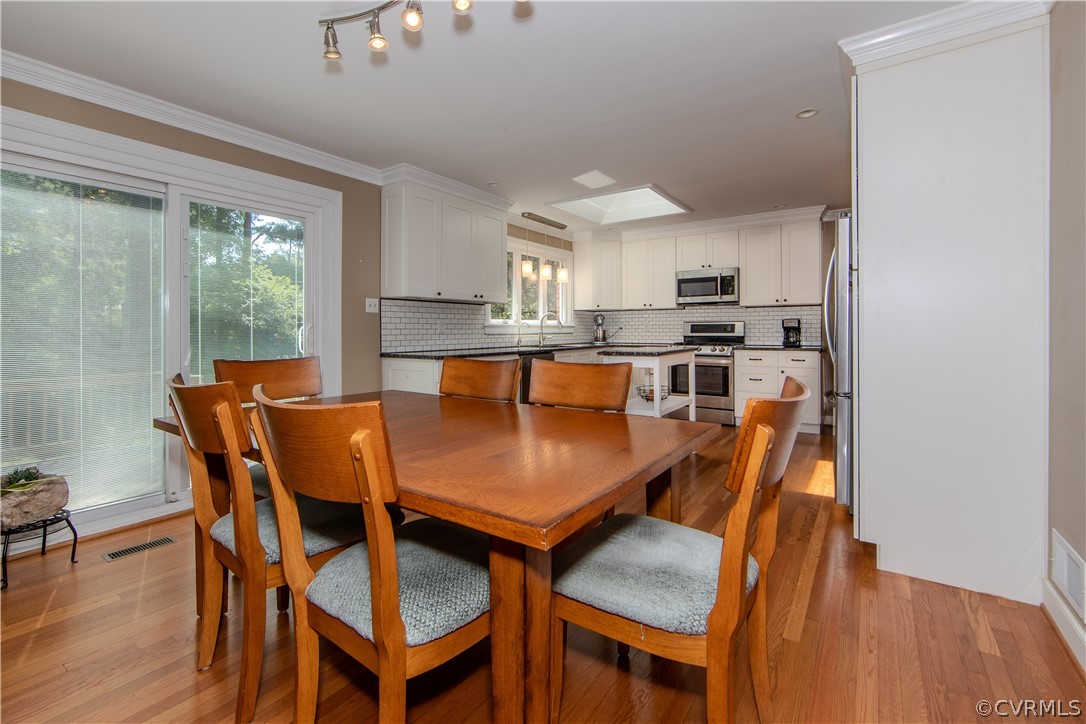 7706 Comanche Drive Richmond, VA 23225 - Photo 9 of 42 a view of a dining room with furniture window and wooden floor