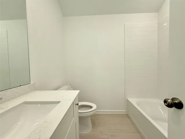 a bathroom with a bathtub and sink