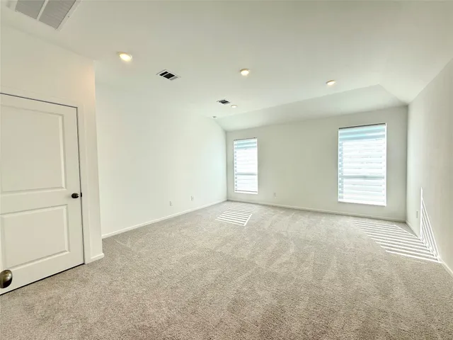 an empty room with windows and closet