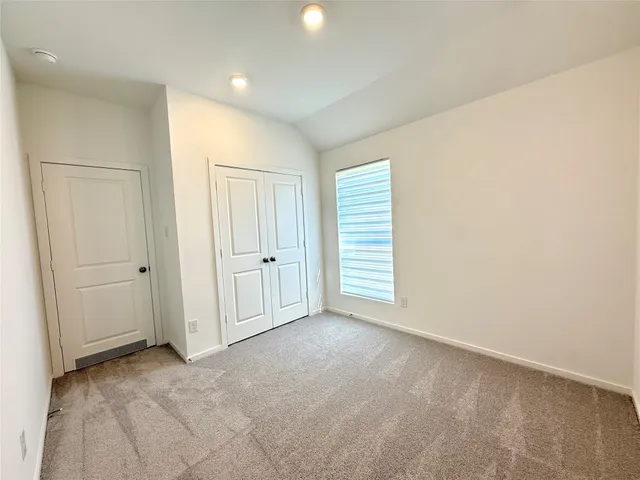 an empty room with closet area