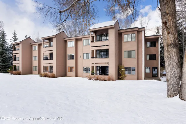 a view of a building with a snow in front of it