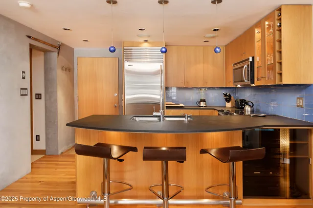 a kitchen with stainless steel appliances granite countertop a sink and cabinets