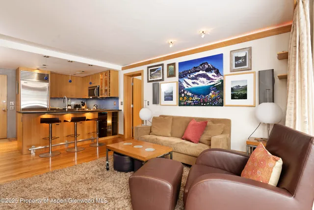 a living room with furniture and kitchen view