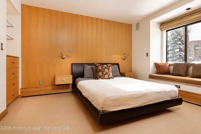 a bedroom with a bed and window