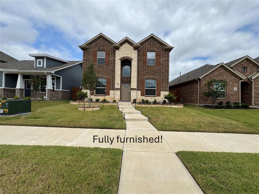 a front view of a house with a yard