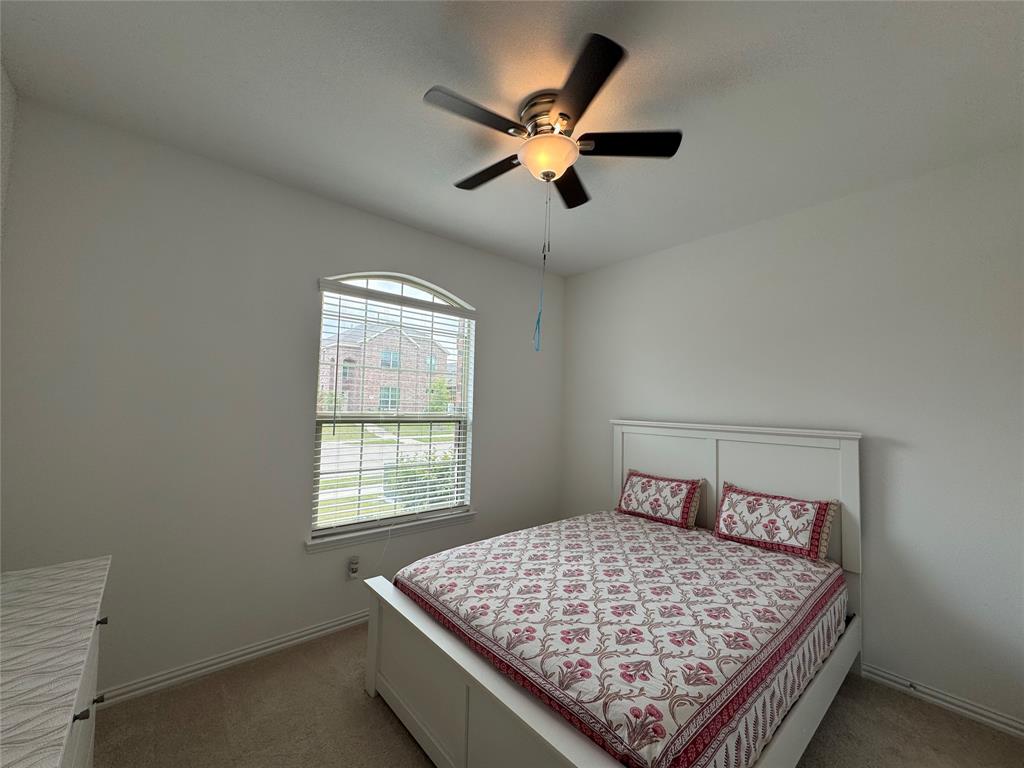 3159 Blossom Trail Crandall, TX 75114 - Photo 15 of 25 a bed sitting in a bedroom next to a window