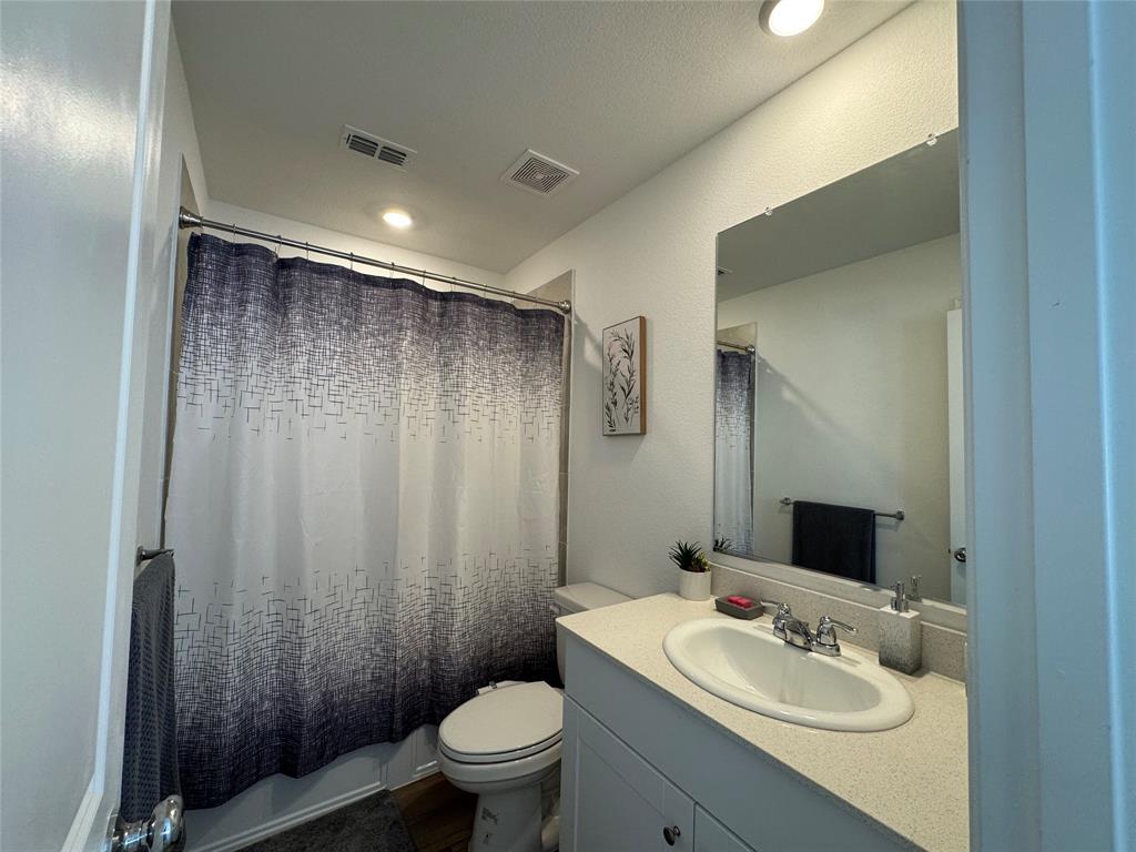 3159 Blossom Trail Crandall, TX 75114 - Photo 20 of 25 a bathroom with a sink toilet and shower