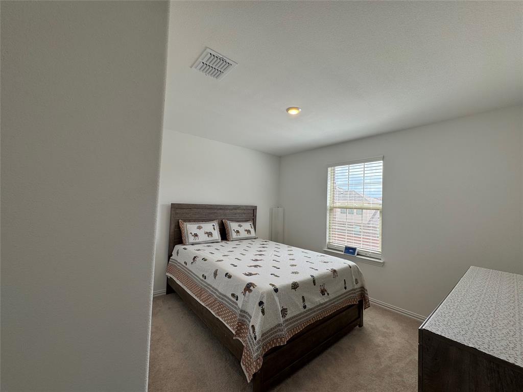 3159 Blossom Trail Crandall, TX 75114 - Photo 21 of 25 a bedroom with a bed and window