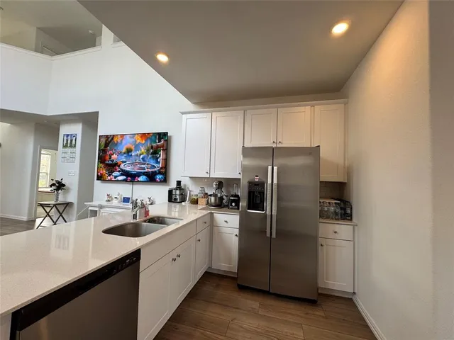 a kitchen with a sink cabinets and stainless steel appliances