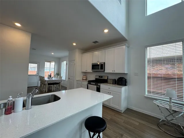 a kitchen with a sink a stove and cabinets