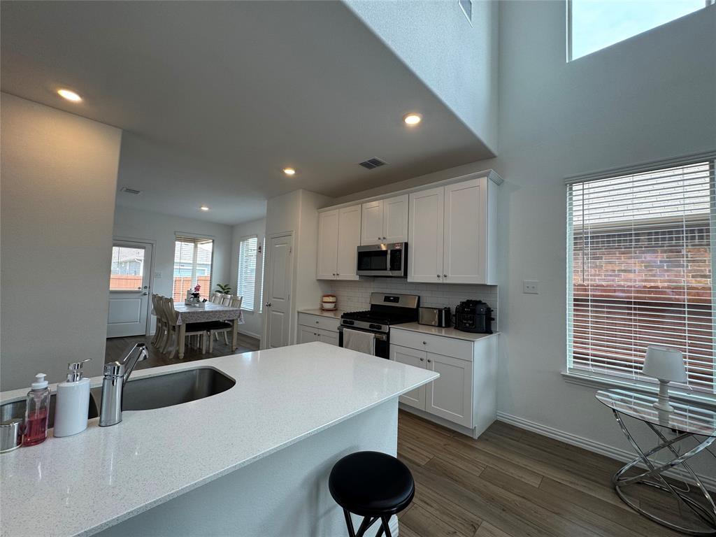 3159 Blossom Trail Crandall, TX 75114 - Photo 10 of 25 a kitchen with a sink a stove and cabinets