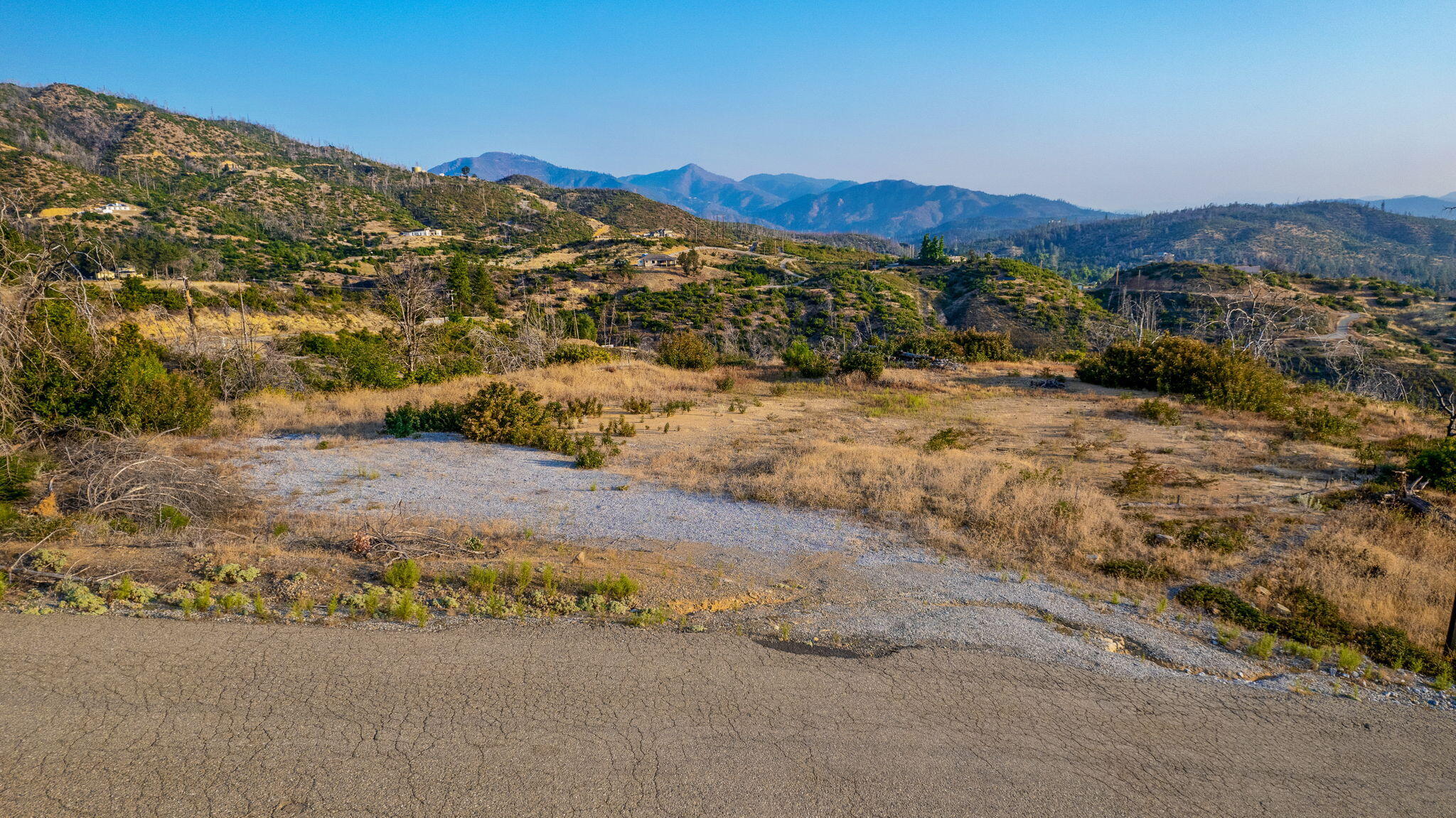 15346 Blackbart Road Shasta, CA 96087 - Photo 10 of 24 a view of a dry yard with mountains in the background