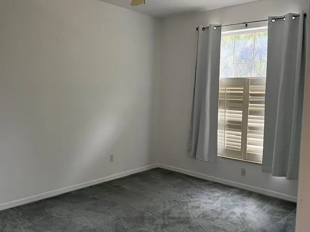 a view of a kitchen with white cabinets