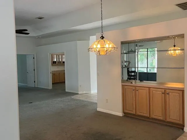 a kitchen with granite countertop a stove sink and refrigerator