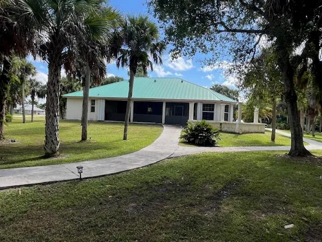 a view of a house with a backyard