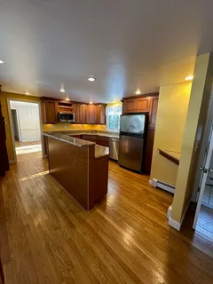 a kitchen with stainless steel appliances granite countertop a sink and a stove top oven