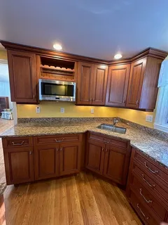 a kitchen with stainless steel appliances granite countertop wooden cabinets a sink and dishwasher