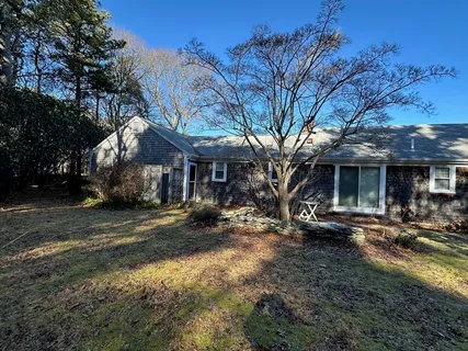a view of a house with a yard and sitting area