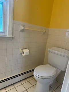 a white toilet sitting next to a bathroom sink