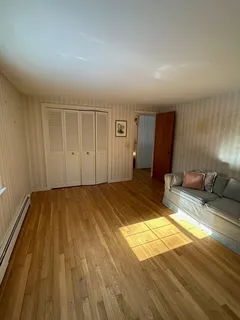 a view of a living room hardwood and kitchen