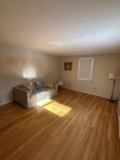 a room with a couch and a table with wooden floor