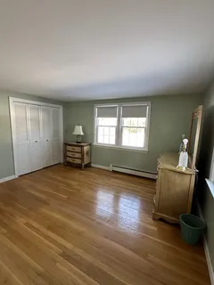 a bedroom with bed and window