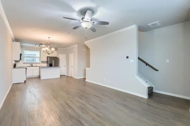 a view of kitchen with granite countertop cabinets and wooden floor