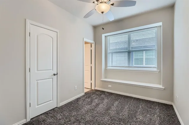 a bathroom with a granite countertop sink toilet mirror and bathtub