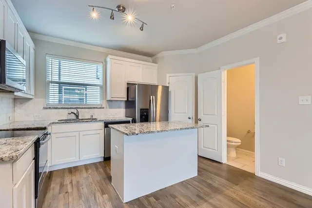 a kitchen with a stove a sink and a refrigerator