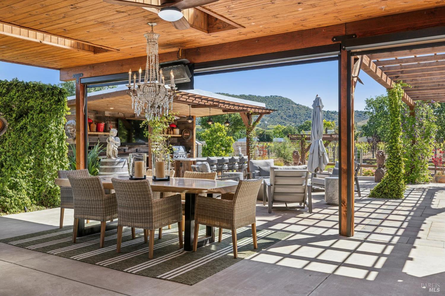21117 Burndale Road Sonoma, CA 95476 - Photo 16 of 48 a view of a patio with table and chairs and potted plants