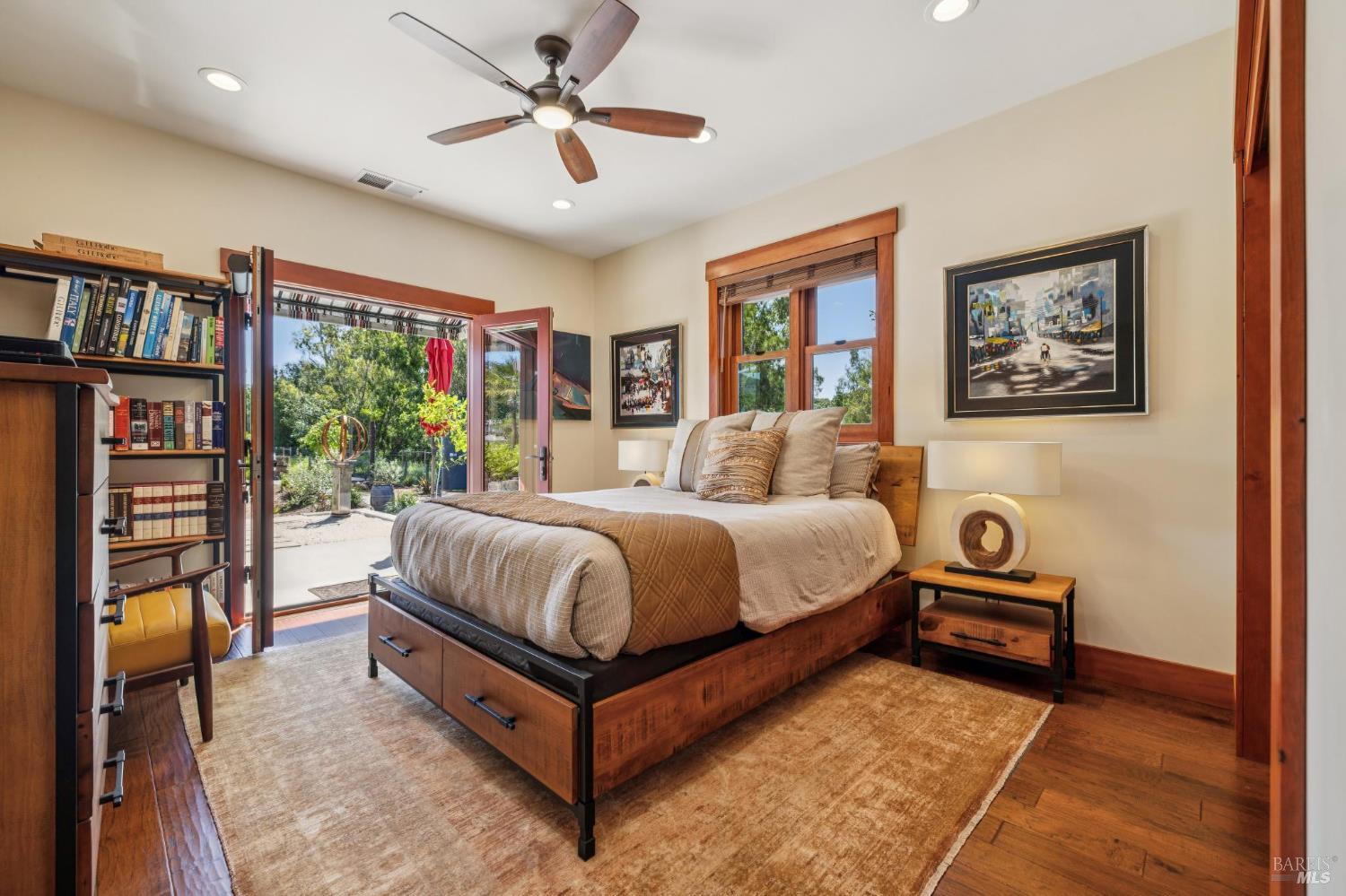 21117 Burndale Road Sonoma, CA 95476 - Photo 20 of 48 a bedroom with a bed and a chandelier