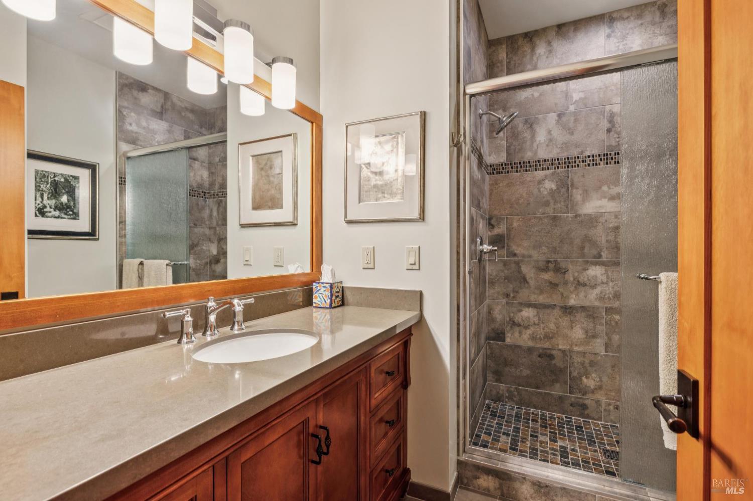 21117 Burndale Road Sonoma, CA 95476 - Photo 25 of 48 a bathroom with a granite countertop shower sink and mirror