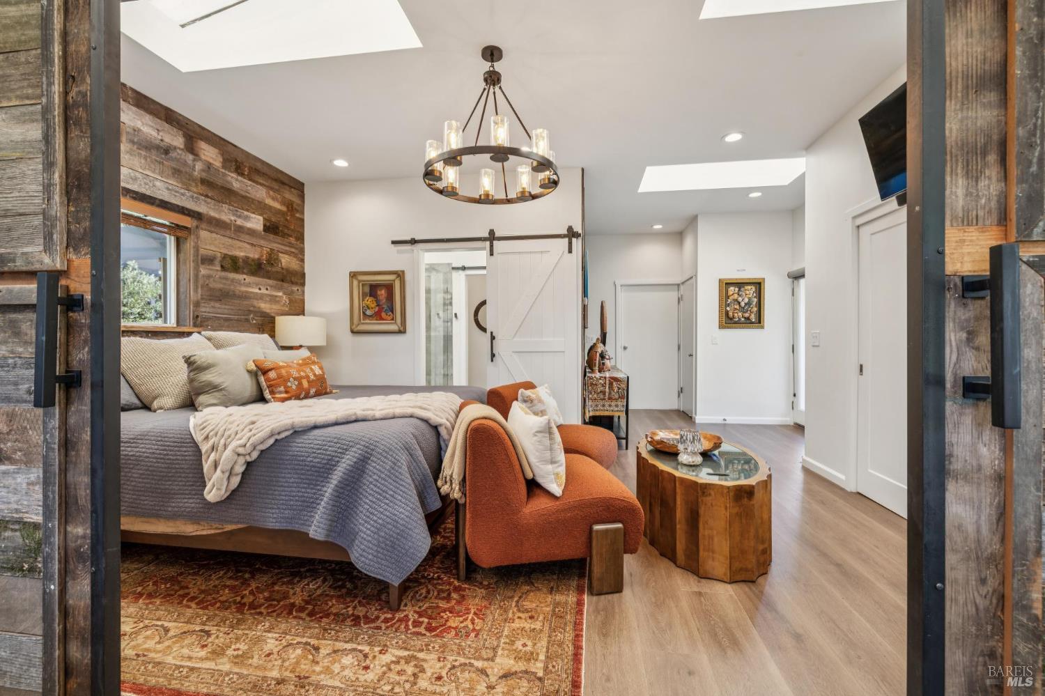 21117 Burndale Road Sonoma, CA 95476 - Photo 30 of 48 a spacious bedroom with a bed and wooden floor