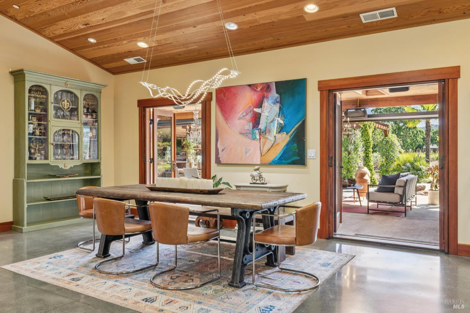 21117 Burndale Road Sonoma, CA 95476 - Photo 10 of 48 a view of a dining room with furniture large windows and wooden floor