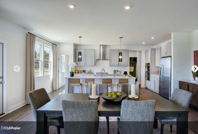 a living room with kitchen island furniture and a kitchen view
