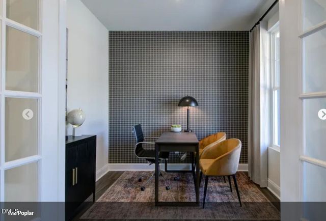 a view of a workspace with furniture and wooden floor