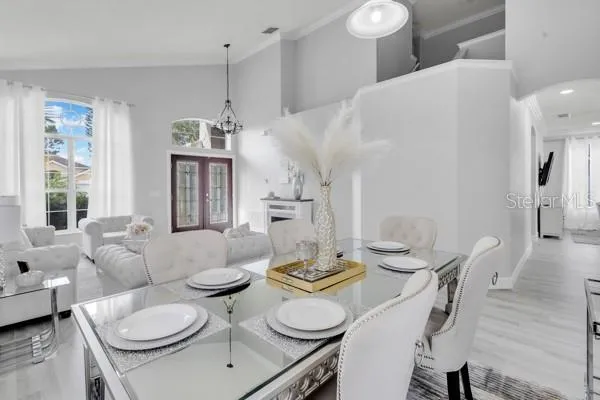 a living room with furniture and a chandelier