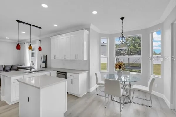 a open kitchen with stainless steel appliances granite countertop a stove and a refrigerator