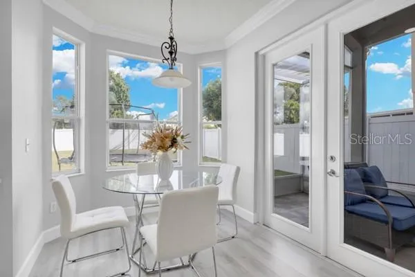 a view of a dining room with furniture and a chandelier