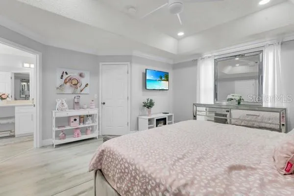 a bedroom with a large bed and a large mirror