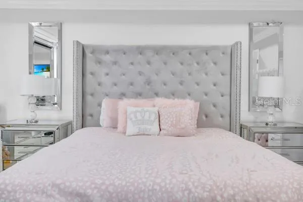 a bedroom with a large bed and a sink