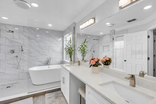 a bathroom with a sink a large mirror and shower