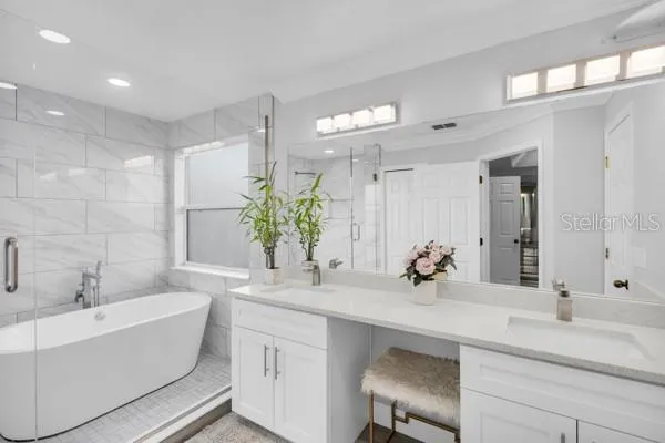 a bathroom with a double vanity sink and a bathtub