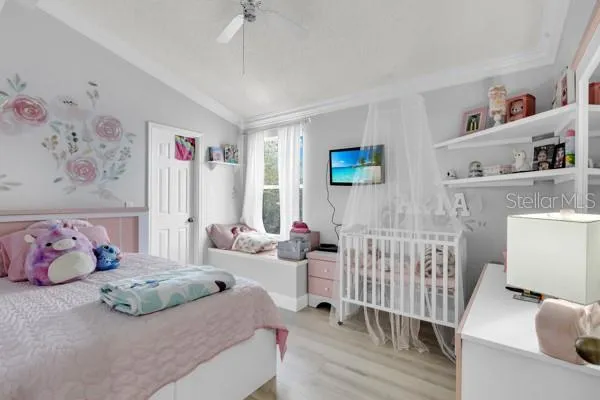 a bedroom with furniture and a baby crib