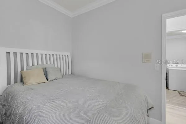 a large bed sitting in a bedroom next to a window