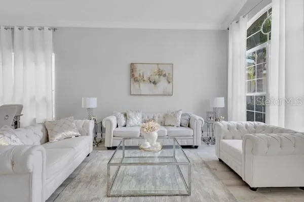 a living room with furniture and a large window